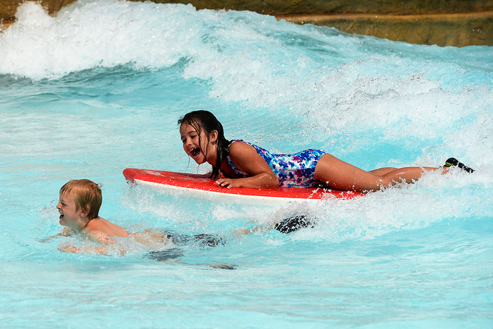 Girl on water board at cowabunga beach, Water World