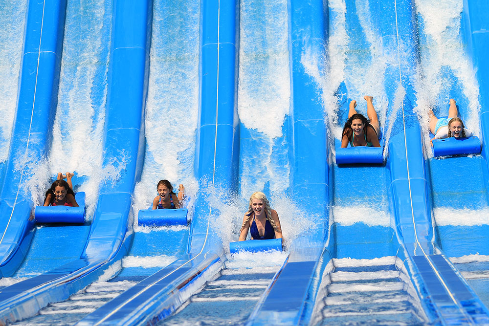 Glazier Run | Water World Colorado Five girls sliding at Glacier Run, Water World