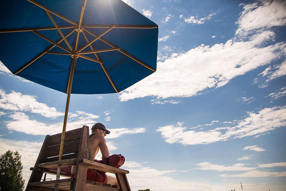 Lifeguard-img02 Young male lifeguard on watch under sun umbrella