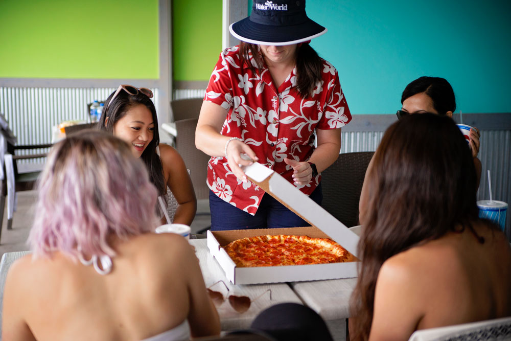 food-and-drink-img07 Four young girl friends eating pizza at water world